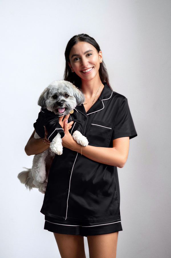 dog mom in matching black pyjamas with her dog